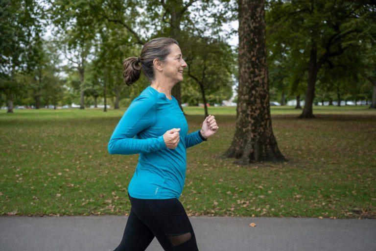 A runner at an easy relaxed jogging pace on a park path