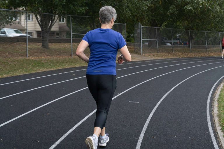 A runner walking a recovery interval on a track